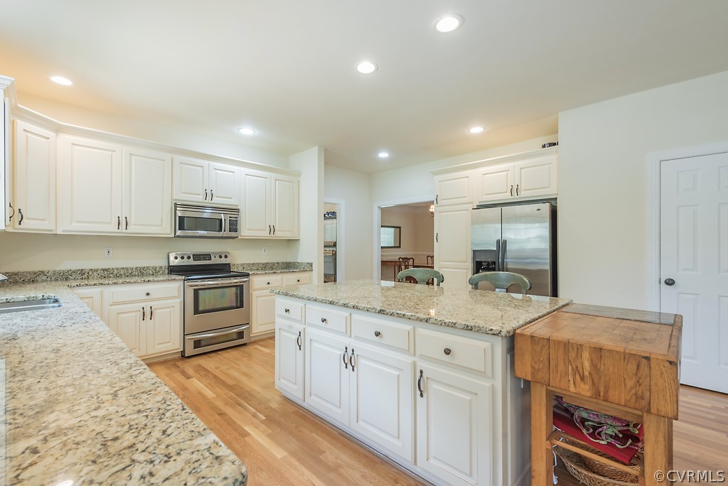 11710 Taplow Road Midlothian, VA 23112 - Photo 24 of 48 a kitchen with granite countertop white cabinets and white appliances
