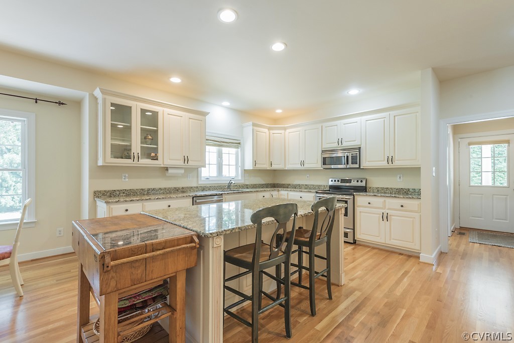 11710 Taplow Road Midlothian, VA 23112 - Photo 26 of 48 a kitchen with a stove a sink and a refrigerator
