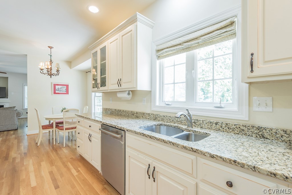 11710 Taplow Road Midlothian, VA 23112 - Photo 27 of 48 a kitchen with a sink dishwasher a stove and white cabinets with wooden floor
