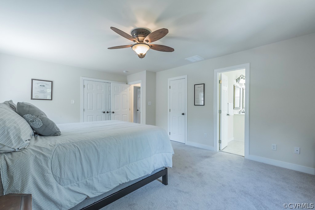 11710 Taplow Road Midlothian, VA 23112 - Photo 33 of 48 a bedroom with a large bed and a chandelier
