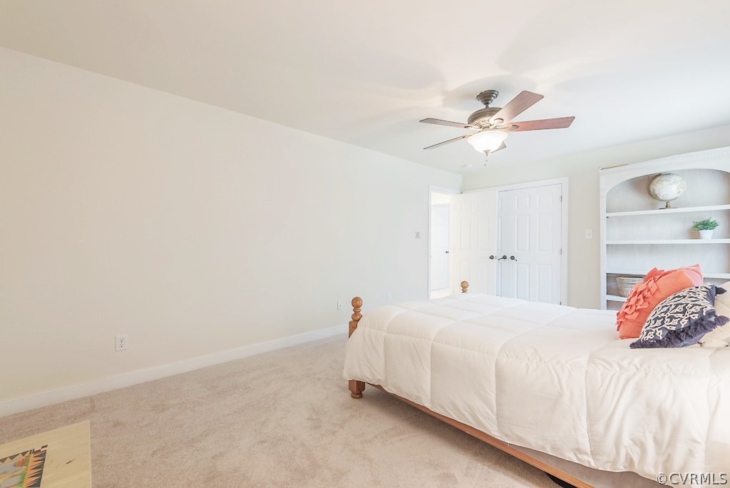 11710 Taplow Road Midlothian, VA 23112 - Photo 38 of 48 a bedroom with a bed and a chandelier