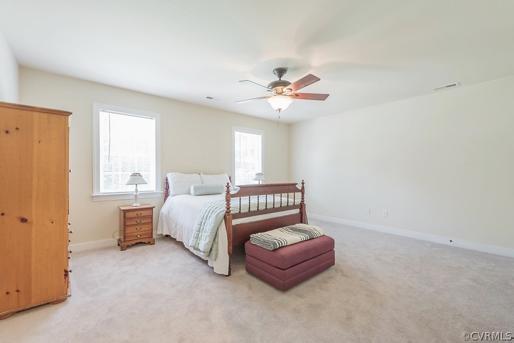 11710 Taplow Road Midlothian, VA 23112 - Photo 39 of 48 a bed room with a bed and a chandelier