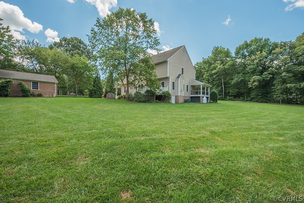11710 Taplow Road Midlothian, VA 23112 - Photo 7 of 48 a front view of a house with a yard and trees