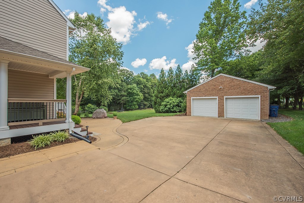 11710 Taplow Road Midlothian, VA 23112 - Photo 10 of 48 a front view of a house with a yard and garage