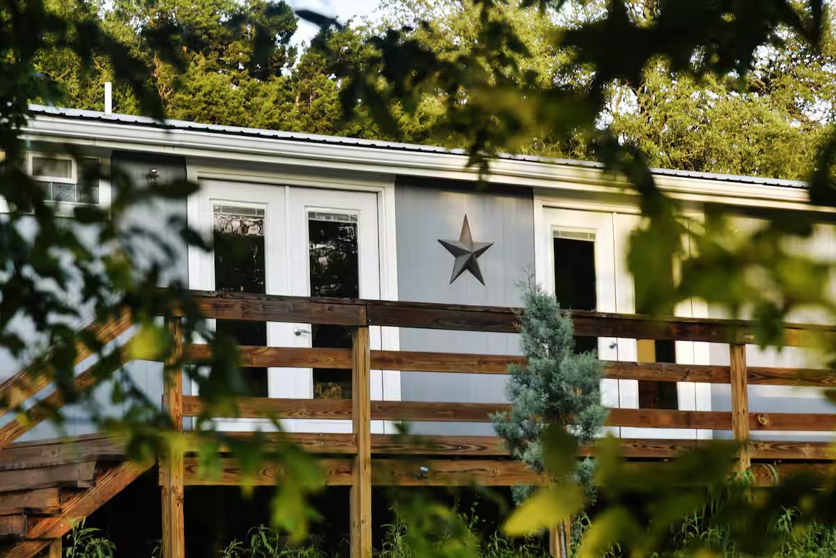 8807 High Valley Road Austin, TX 78737 - Photo 22 of 22 A charming exterior with a wooden deck offers a private connection to nature.
