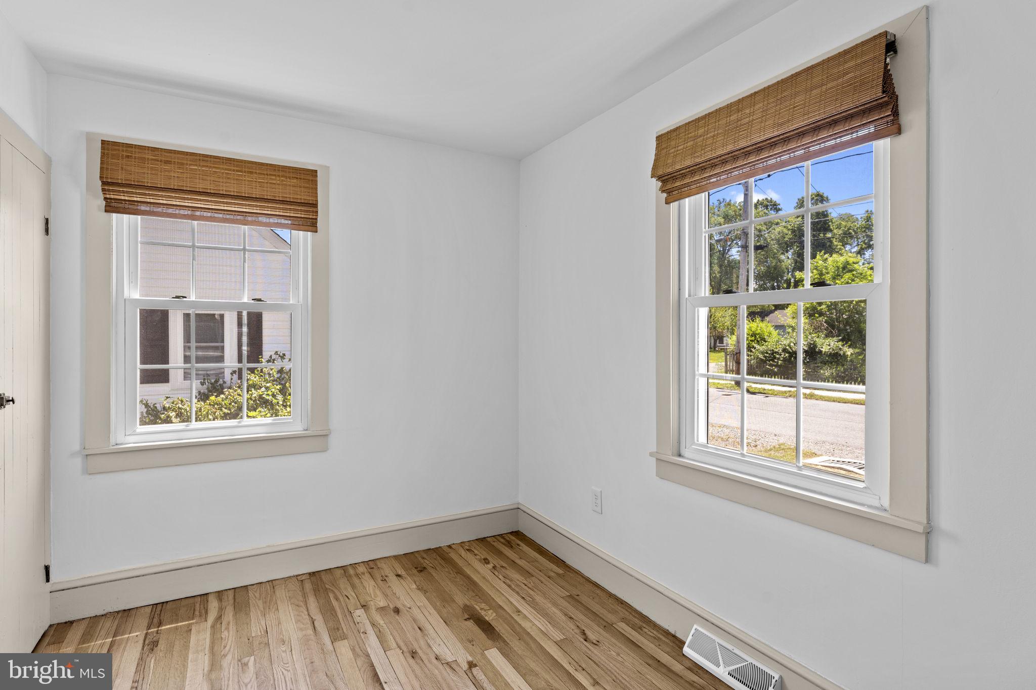 216 Walnut Street Berryville, VA 22611 - Photo 19 of 36 a view of an empty room with wooden floor and a window