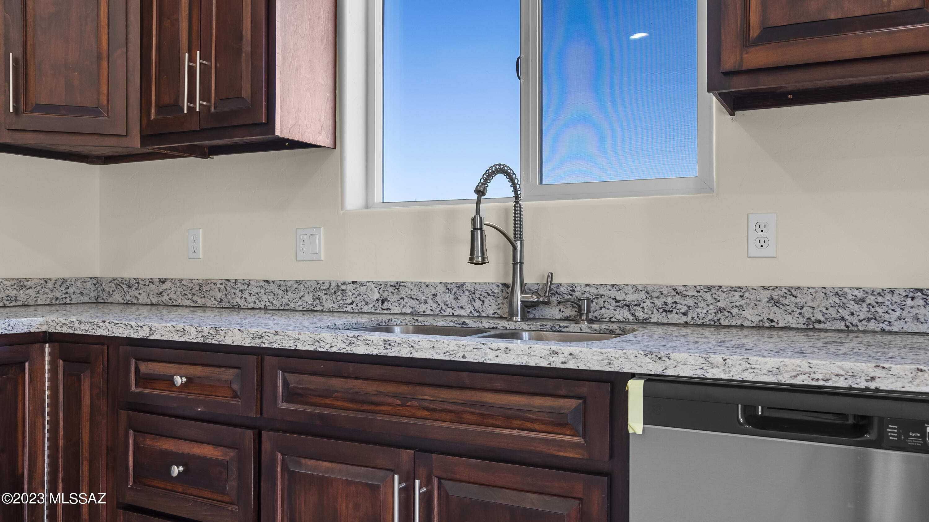 1799 Saltillo Court Rio Rico, AZ 85648 - Photo 7 of 25 a kitchen with granite countertop a sink and cabinets