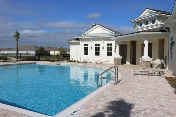 a front view of a house with yard porch and sitting area