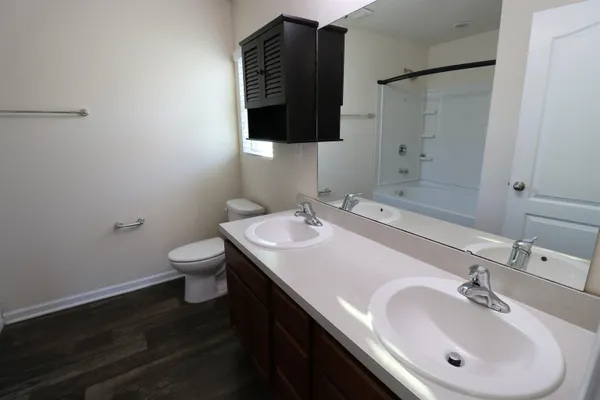 a bathroom with a sink toilet and mirror