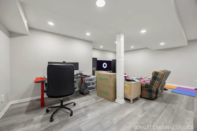 a view of a workspace with furniture and a window