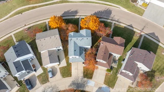 an aerial view of residential house with outdoor space and parking