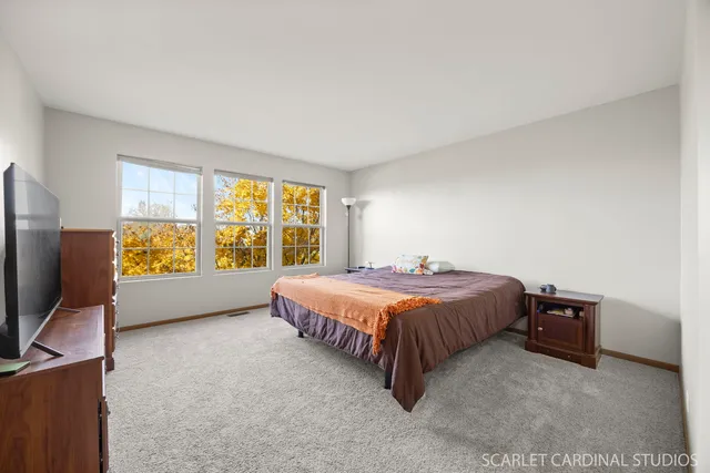 a bed sitting in a room next to a window