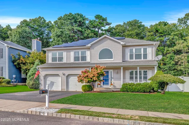 a front view of a house with a garden