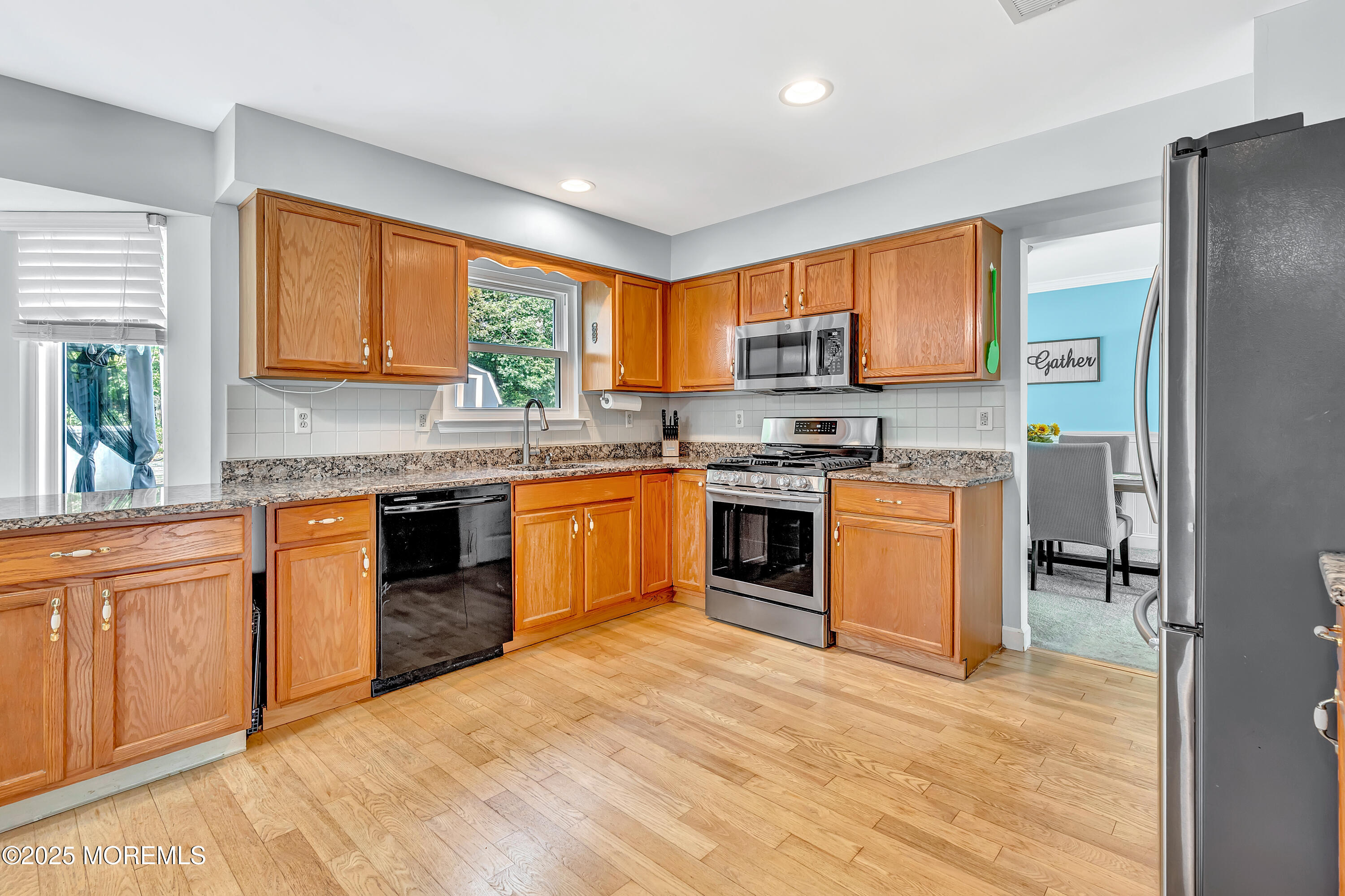 66 Diamond Lane Howell, NJ 07731 - Photo 12 of 47 a kitchen with stainless steel appliances granite countertop a stove top oven a sink dishwasher and a refrigerator