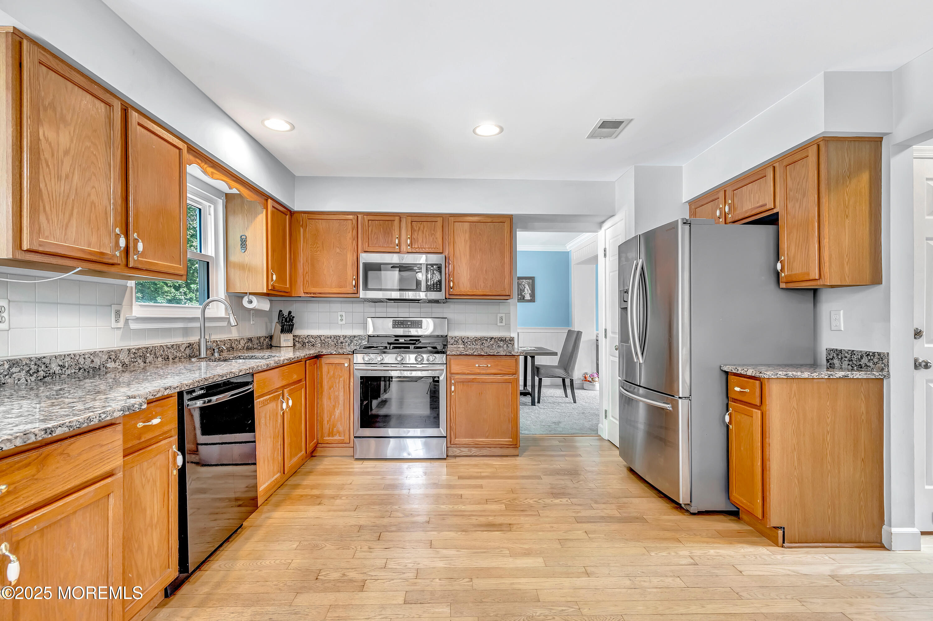 66 Diamond Lane Howell, NJ 07731 - Photo 13 of 47 a kitchen with stainless steel appliances granite countertop a refrigerator stove top oven and sink