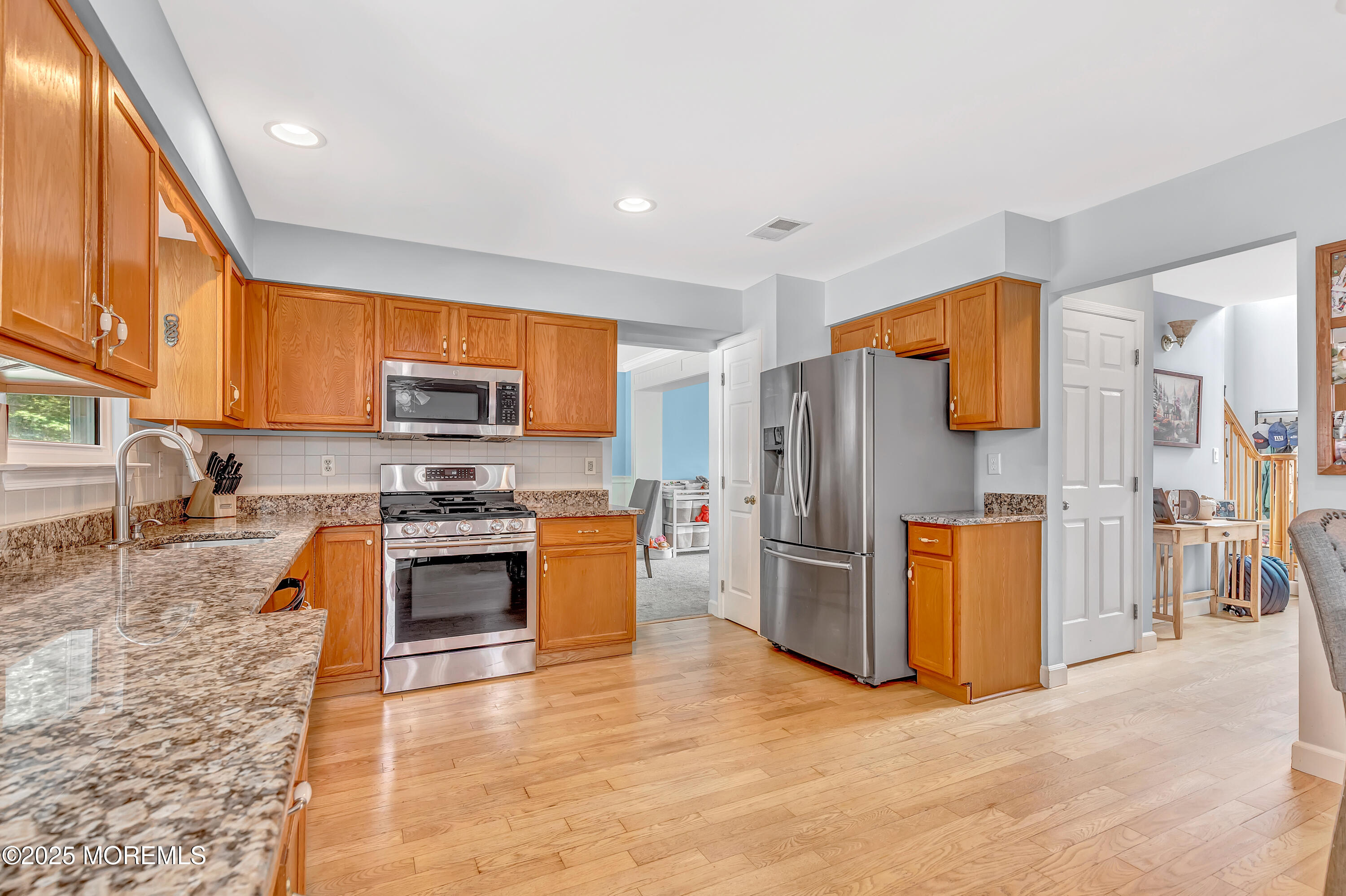 66 Diamond Lane Howell, NJ 07731 - Photo 14 of 47 a kitchen with stainless steel appliances granite countertop a refrigerator a stove top oven and a sink