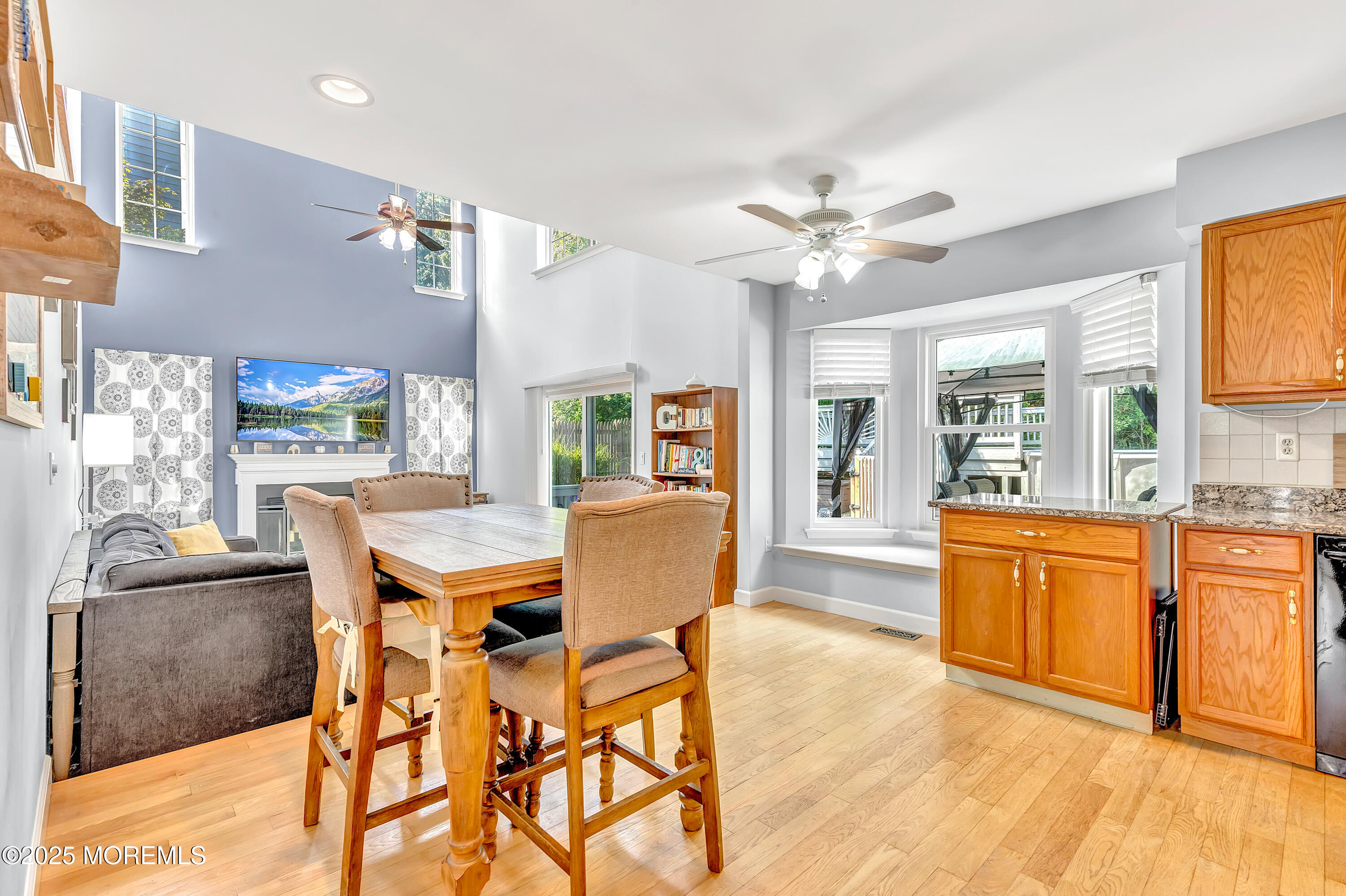 66 Diamond Lane Howell, NJ 07731 - Photo 17 of 47 a dining room with stainless steel appliances kitchen island granite countertop a table chairs and a refrigerator