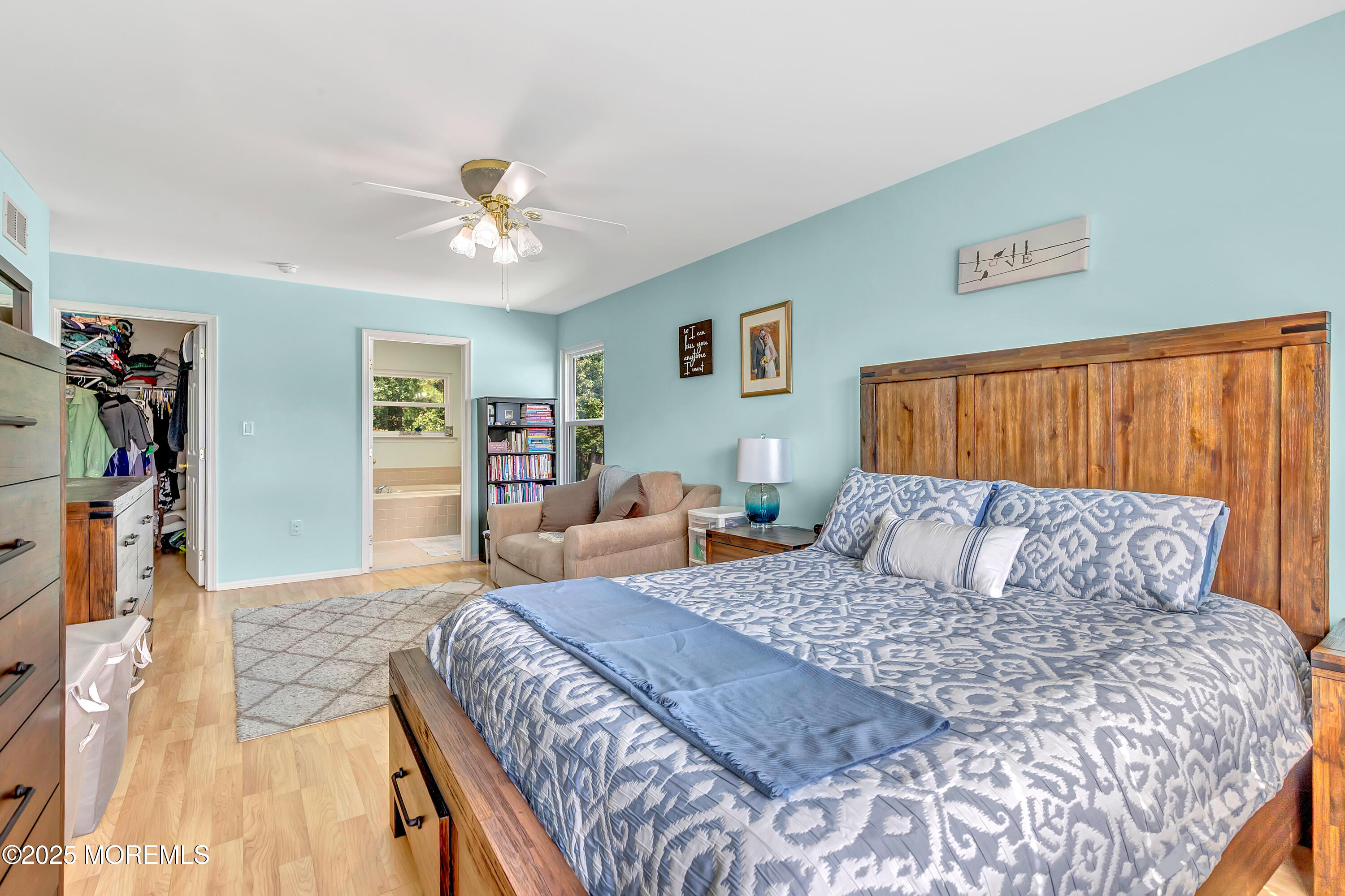 66 Diamond Lane Howell, NJ 07731 - Photo 25 of 47 a bedroom with a large bed and a chandelier