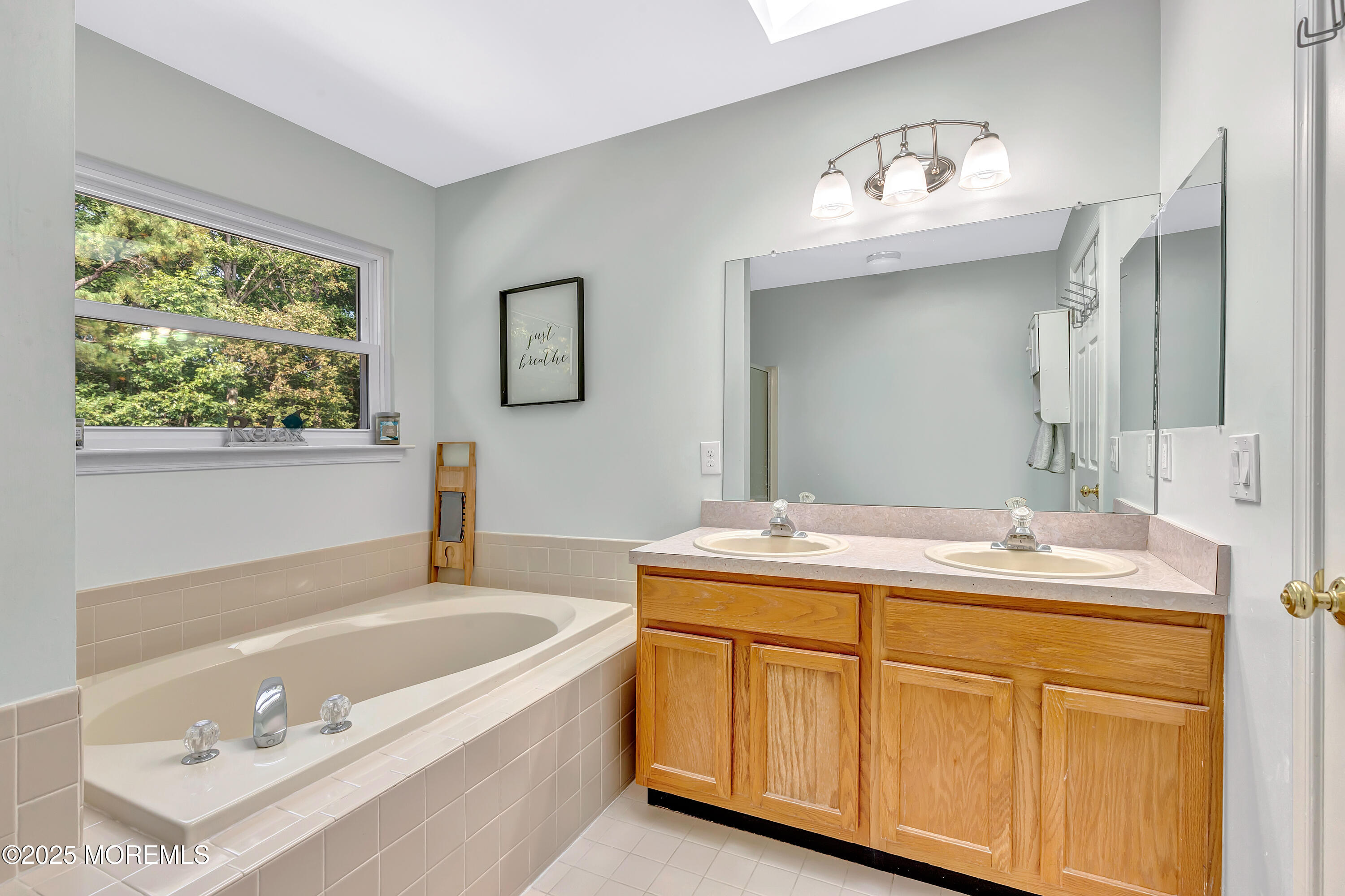 66 Diamond Lane Howell, NJ 07731 - Photo 26 of 47 a bathroom with a tub a sink and mirror