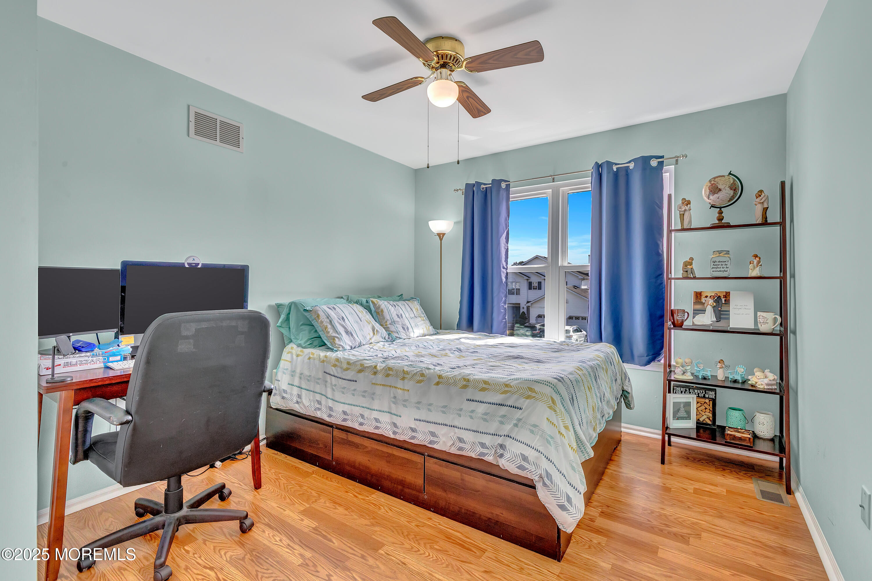 66 Diamond Lane Howell, NJ 07731 - Photo 29 of 47 a bedroom with a bed and a chair with the bookshelf