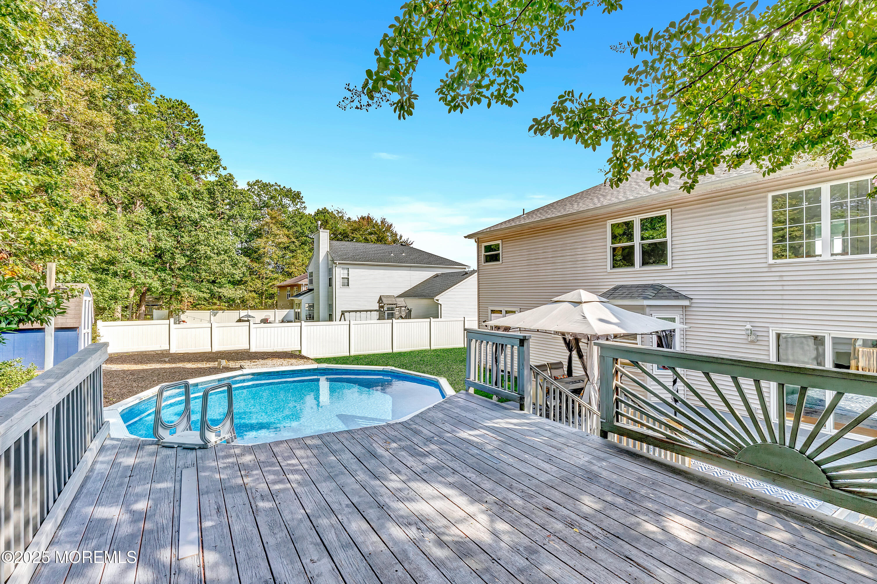 66 Diamond Lane Howell, NJ 07731 - Photo 42 of 47 a view of a wooden deck and a patio with swimming pool