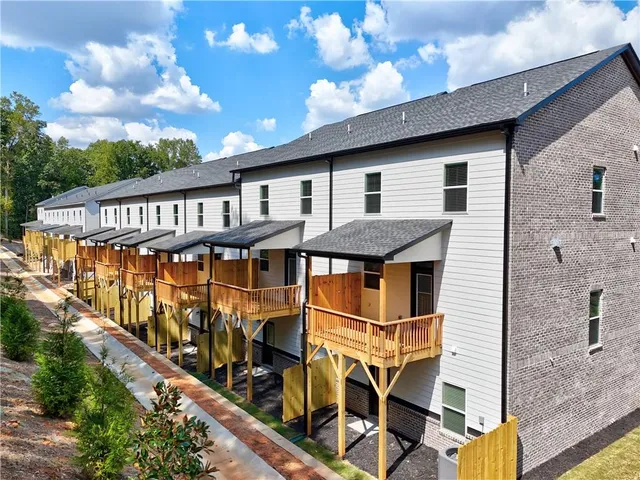 a view of a house with wooden deck
