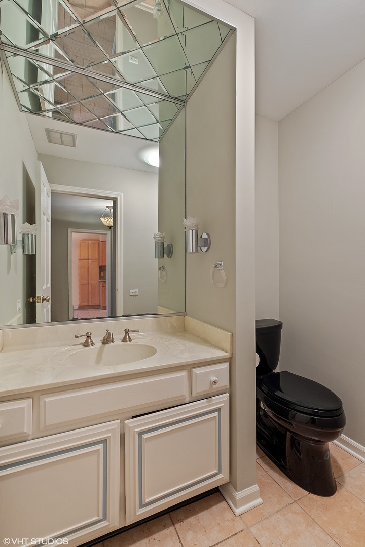 3833 Mission Hills Road, Unit 2B Northbrook, IL 60062 - Photo 10 of 24 a bathroom with a sink and a mirror