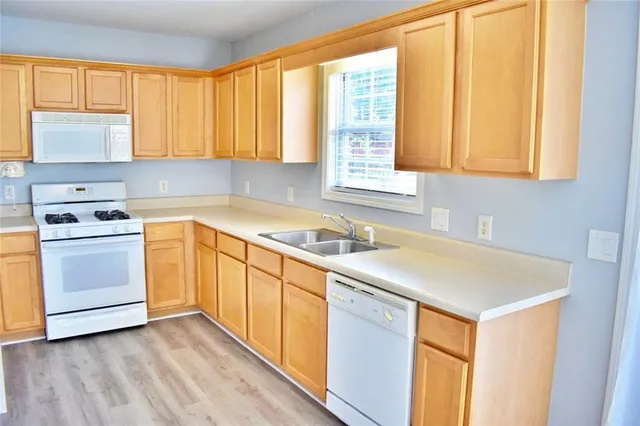a kitchen with appliances cabinets and a sink