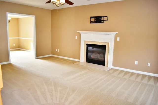 a view of an empty room with a fireplace