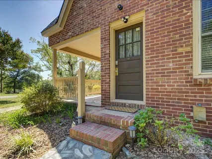 a view of a brick house with a yard
