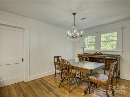 a view of a dining room with furniture and chandelier