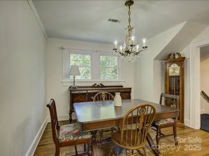 a view of a dining room with furniture and a chandelier