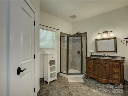 a bathroom with a granite countertop sink a mirror a shower and a bathtub