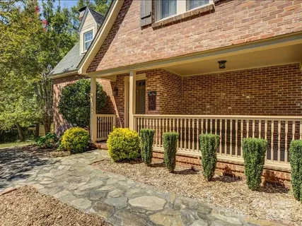 a view of a chair and table in the back yard