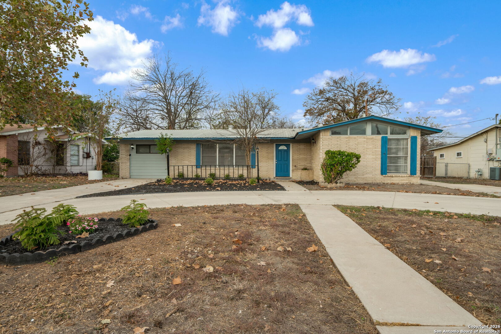 a front view of a house with a garden