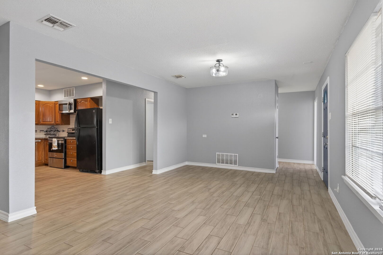 4531 Eisenhauer Road San Antonio, TX 78218 - Photo 17 of 32 a view of an empty room with kitchen view and a window