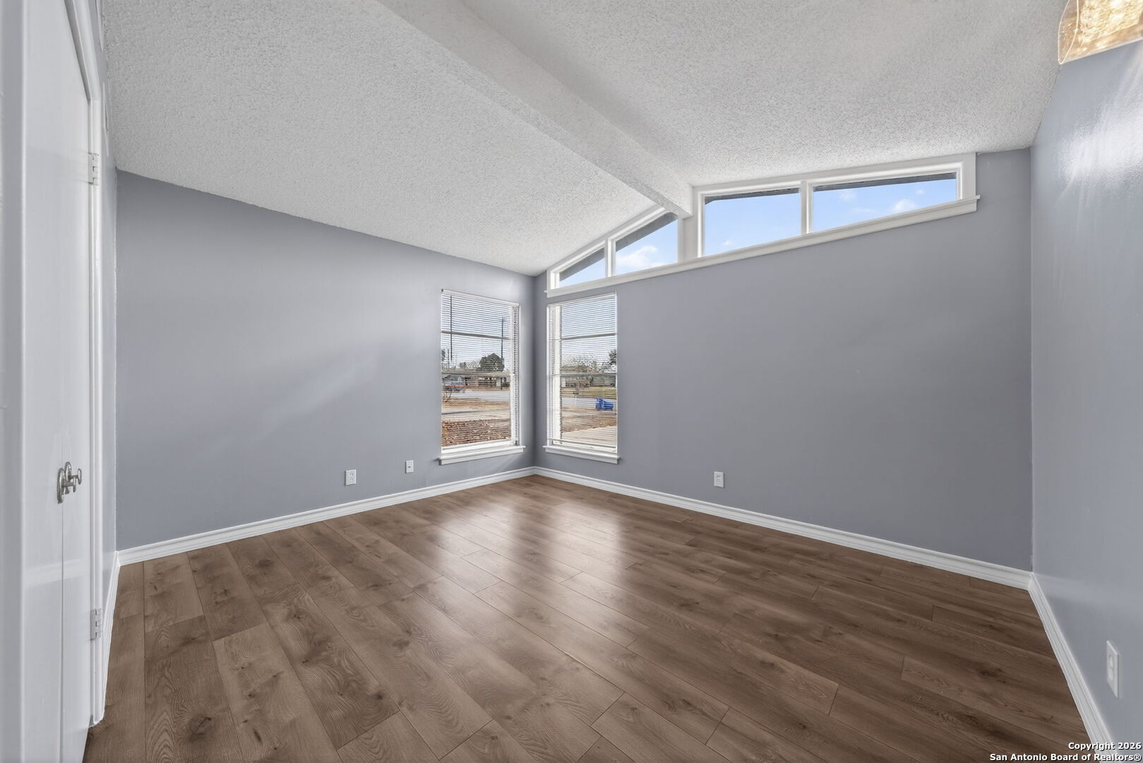 4531 Eisenhauer Road San Antonio, TX 78218 - Photo 25 of 32 a view of an empty room with wooden floor and a window