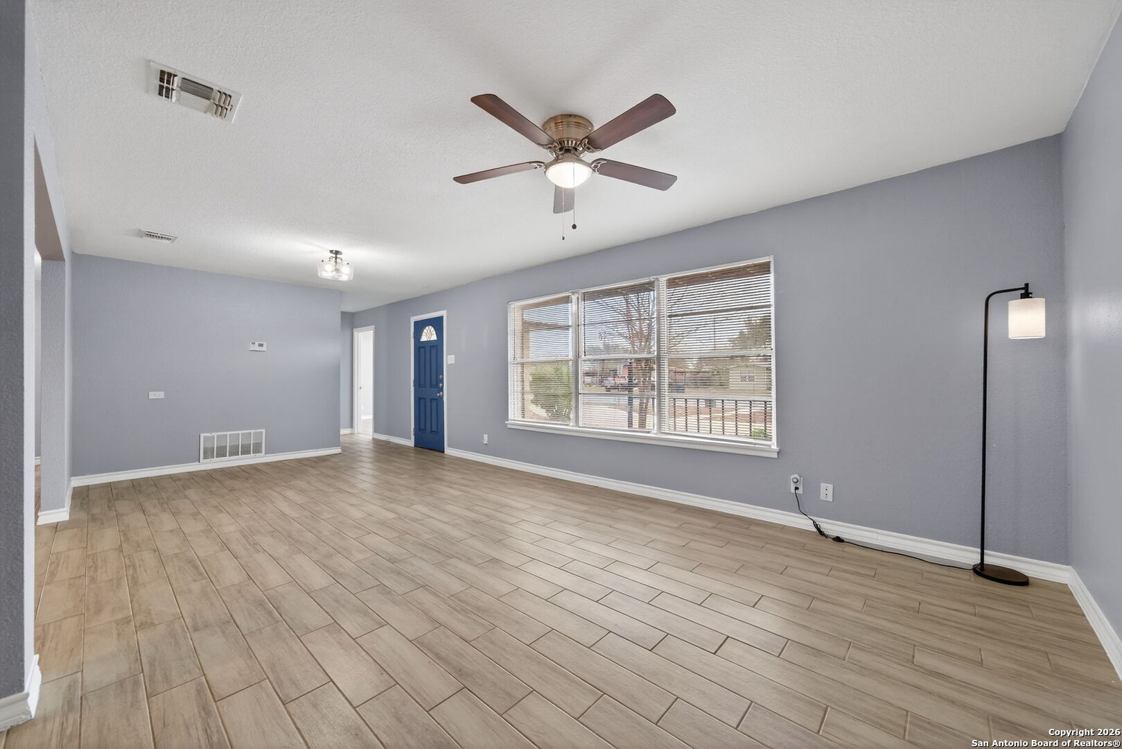 4531 Eisenhauer Road San Antonio, TX 78218 - Photo 10 of 32 a view of an empty room with wooden floor and a window