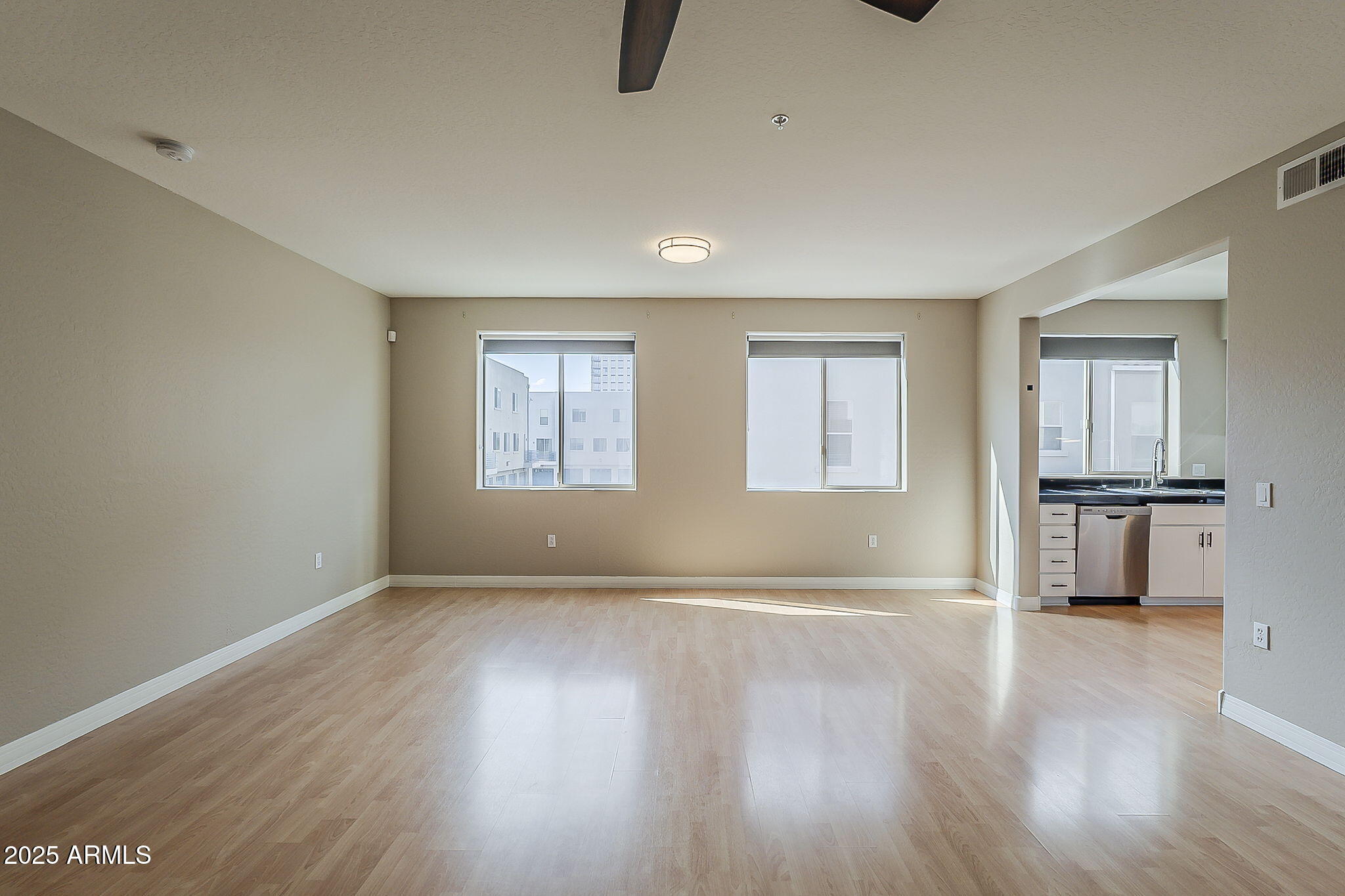 615 East Portland Street, Unit 277 Phoenix, AZ 85004 - Photo 10 of 39 an empty room with wooden floor and windows