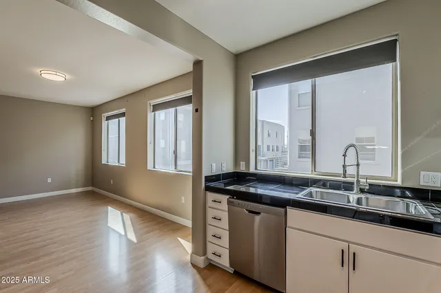 a kitchen with stainless steel appliances granite countertop a sink a stove a microwave and cabinets