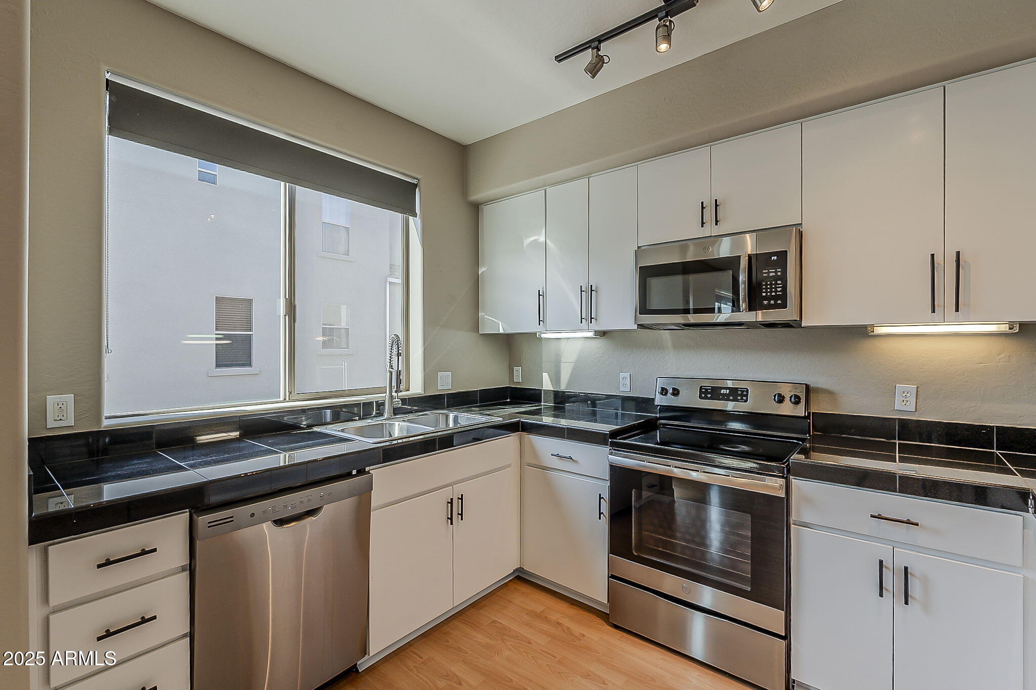 615 East Portland Street, Unit 277 Phoenix, AZ 85004 - Photo 13 of 39 a kitchen with stainless steel appliances granite countertop a sink a stove a microwave and cabinets