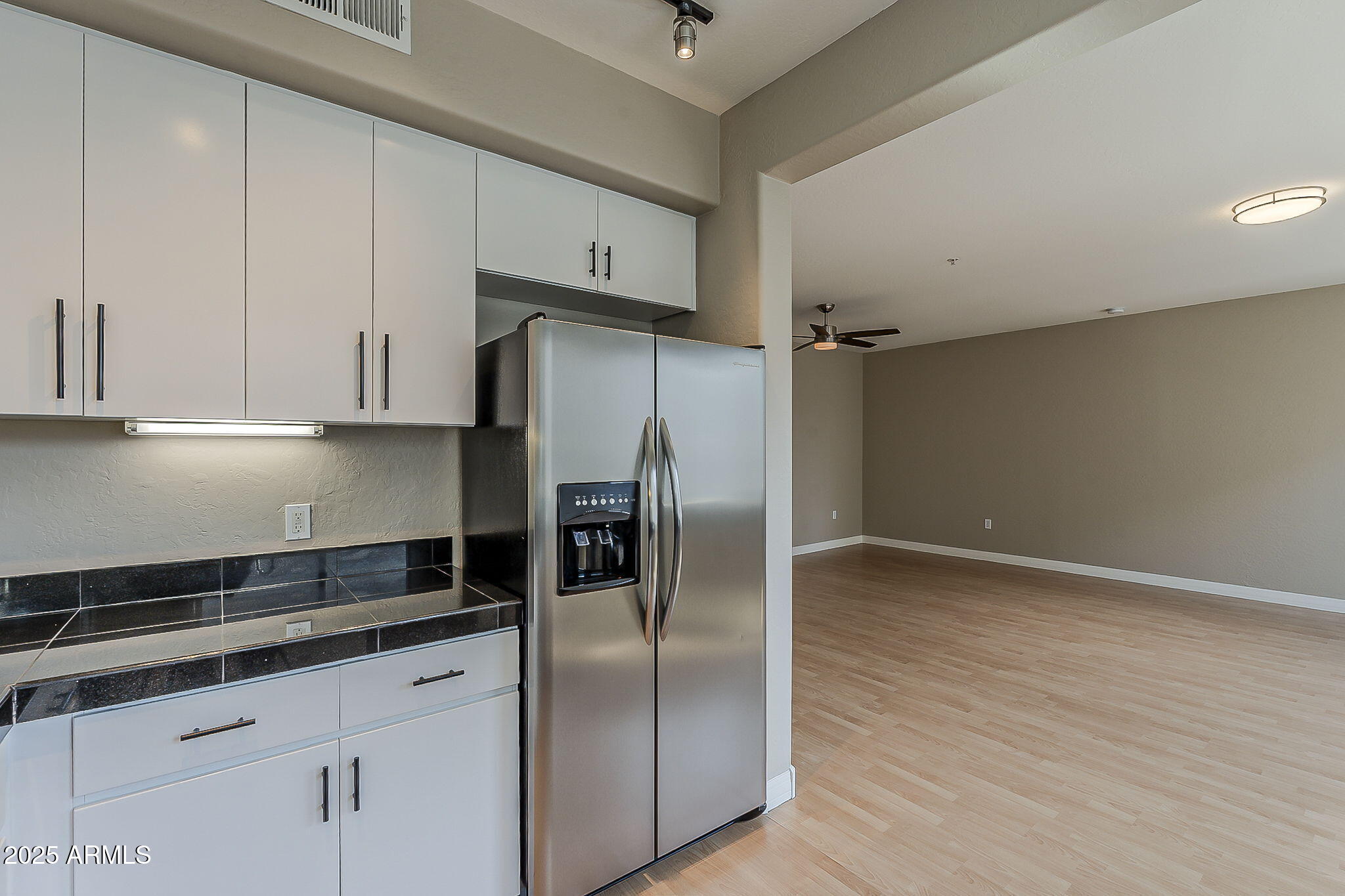 615 East Portland Street, Unit 277 Phoenix, AZ 85004 - Photo 15 of 39 a kitchen with granite countertop a refrigerator and a sink