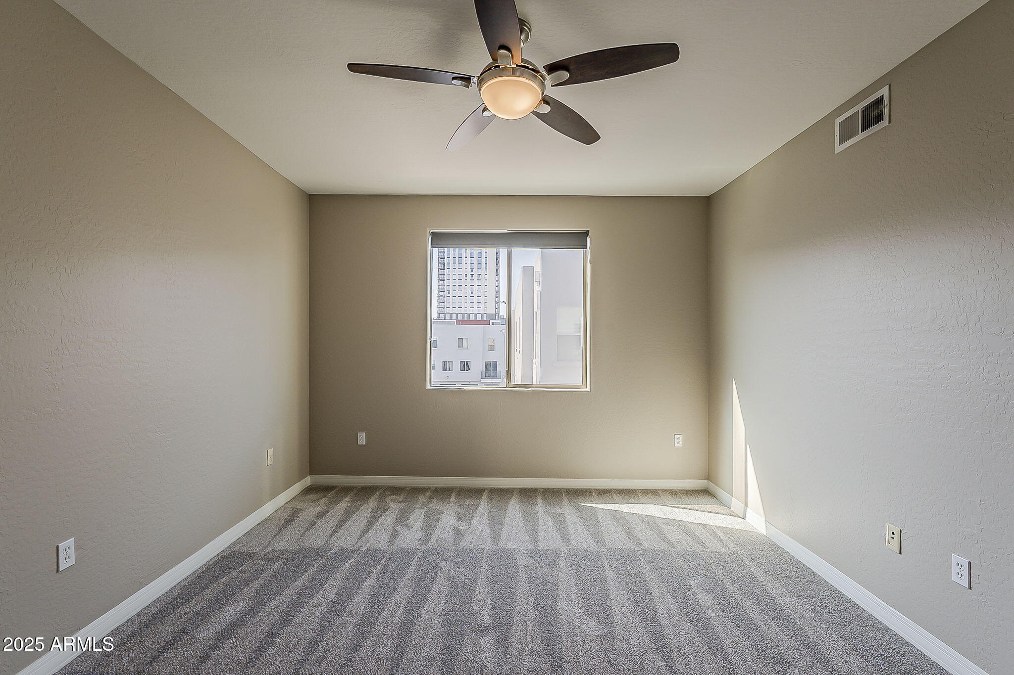 615 East Portland Street, Unit 277 Phoenix, AZ 85004 - Photo 24 of 39 wooden floor in an empty room with a window