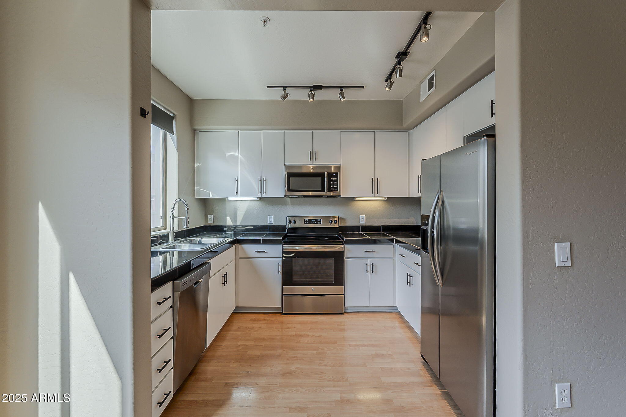 615 East Portland Street, Unit 277 Phoenix, AZ 85004 - Photo 7 of 39 a kitchen with stainless steel appliances granite countertop a stove and a refrigerator