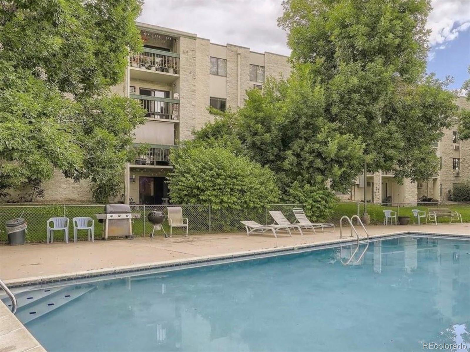 a view of swimming pool with outdoor seating and plants