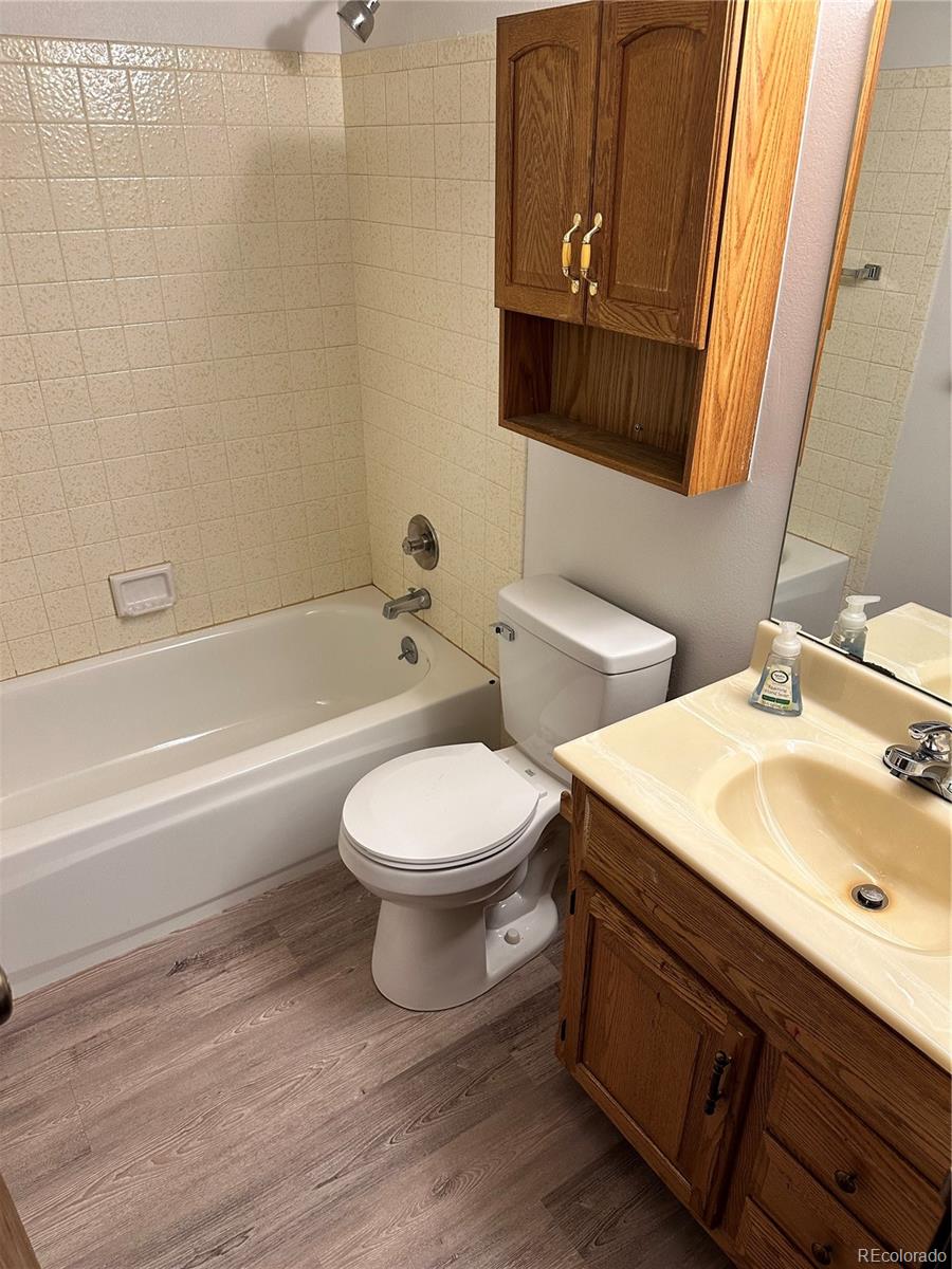 7780 West 38th Avenue, Unit 302 Wheat Ridge, CO 80033 - Photo 13 of 24 a bathroom with a sink a toilet and bathtub