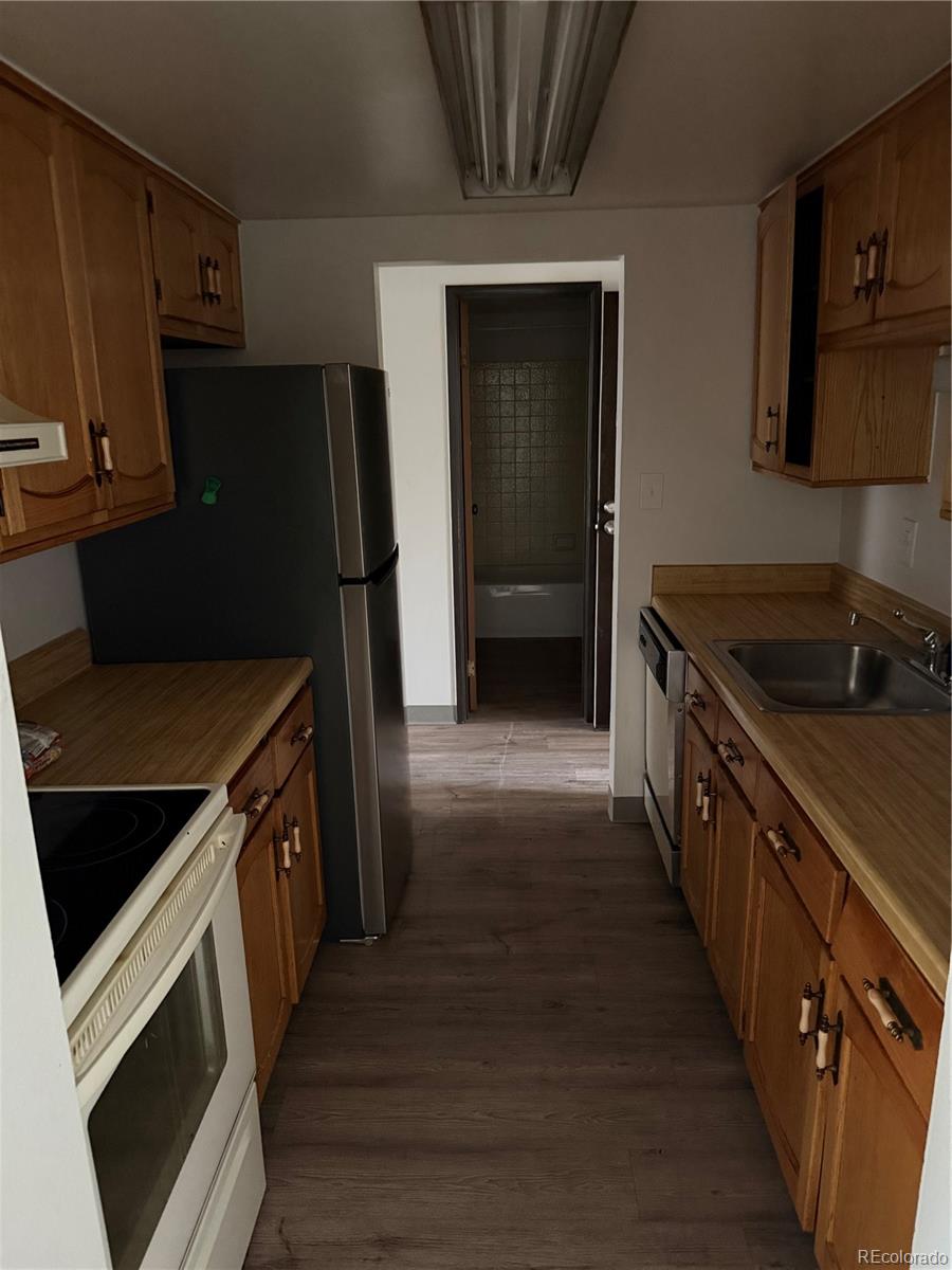 7780 West 38th Avenue, Unit 302 Wheat Ridge, CO 80033 - Photo 14 of 17 a kitchen with a stove and a refrigerator