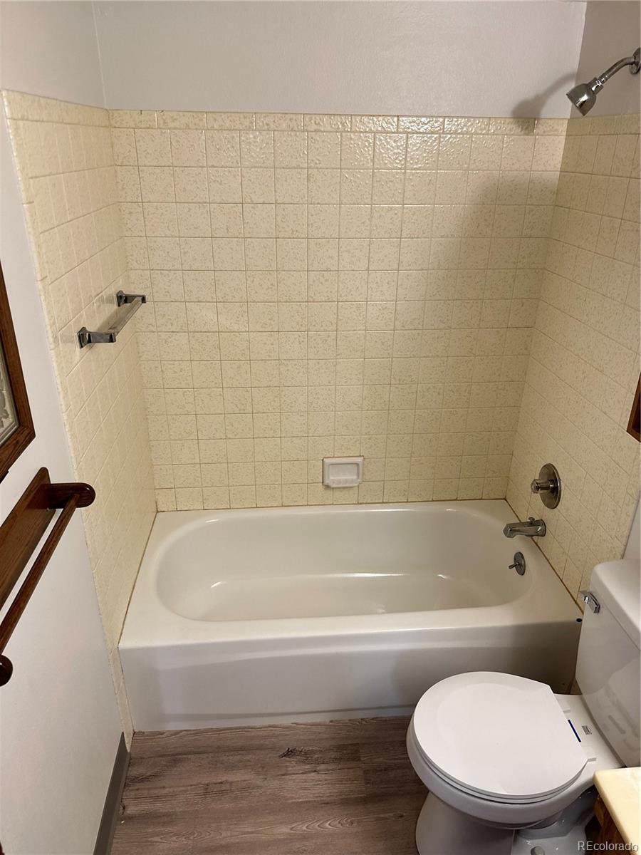 7780 West 38th Avenue, Unit 302 Wheat Ridge, CO 80033 - Photo 14 of 24 a bathroom with a toilet and bathtub