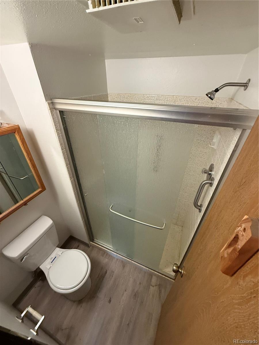 7780 West 38th Avenue, Unit 302 Wheat Ridge, CO 80033 - Photo 5 of 17 a white toilet sitting next to a shower