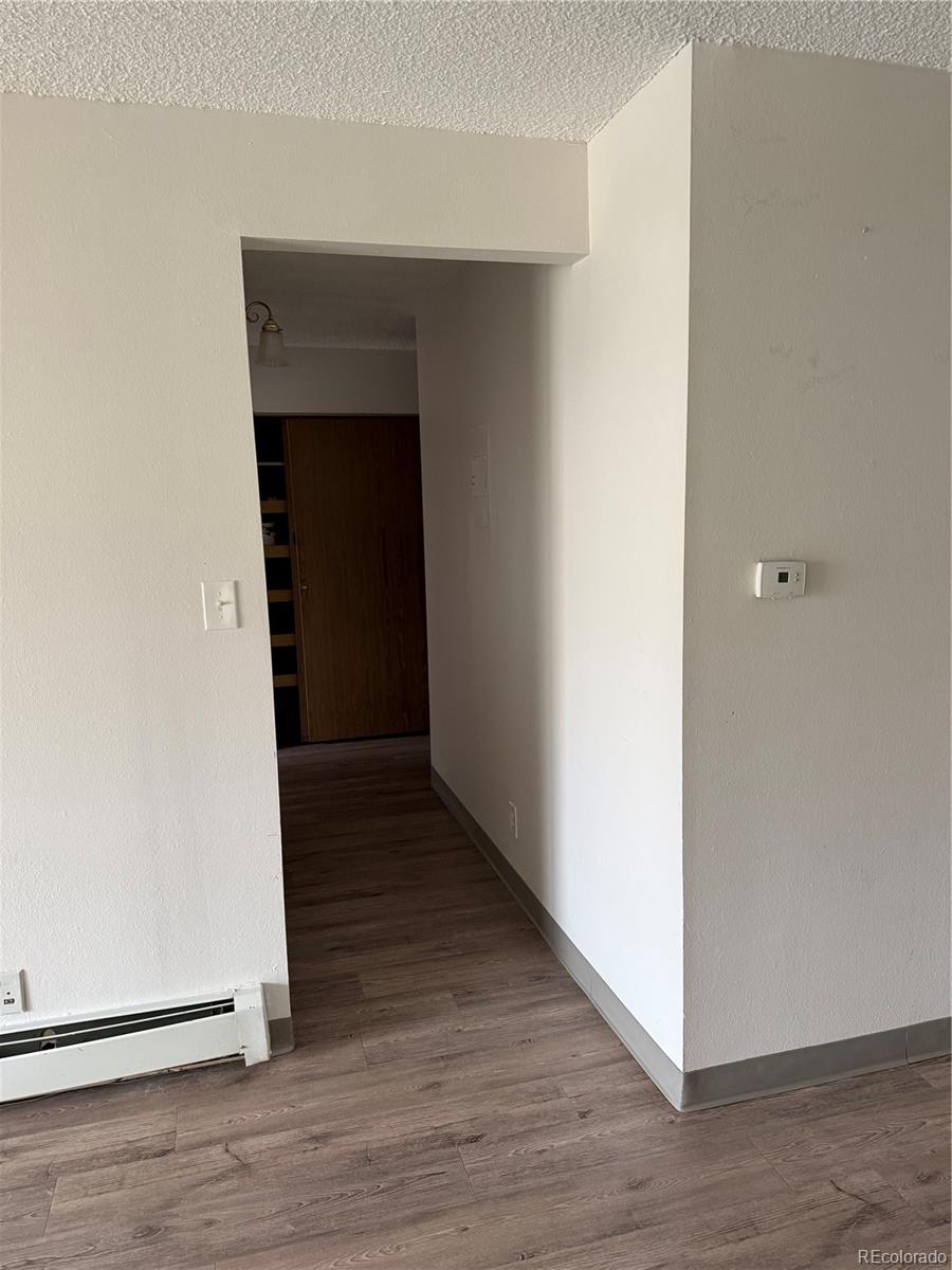 7780 West 38th Avenue, Unit 302 Wheat Ridge, CO 80033 - Photo 9 of 17 a view of a hallway with wooden floor